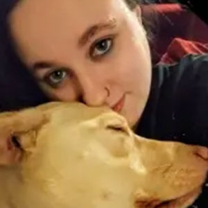 Rachel snuggling a sleeping dog