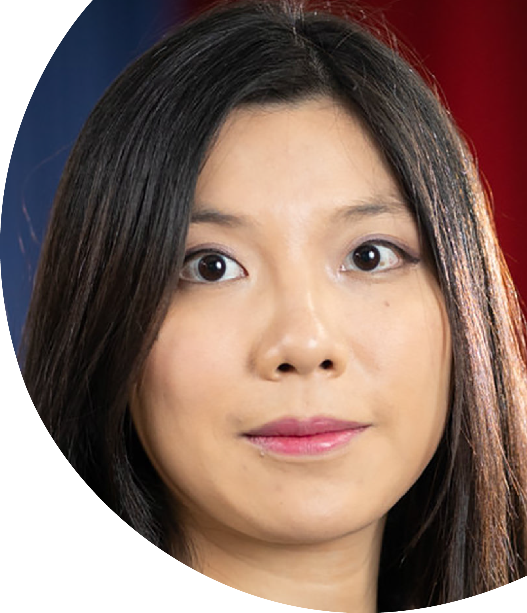 Woman with long dark hair against a red and blue background.