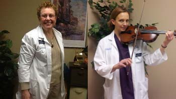 A female Dietician playing a violin while another female Dietician smiles