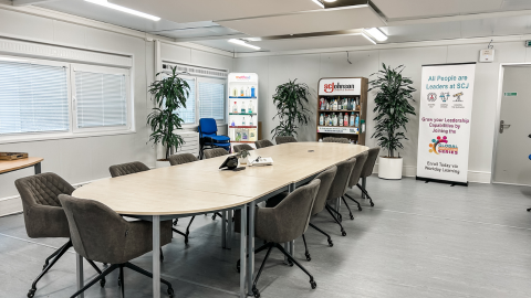 Conference room table with LSB products on shelf behind