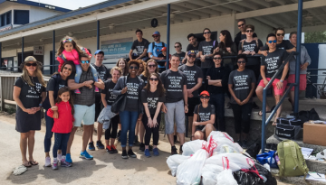 SCJ Chicago team members posing for a group photo at a volunteering event; Team shirts read "Save the Ocean from Plastic"