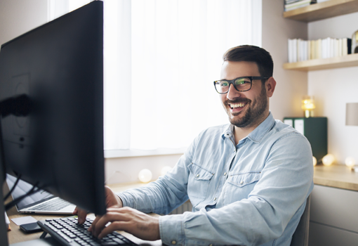 Engineer smiling at a screen