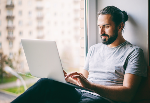 young engineer working on laptop at home