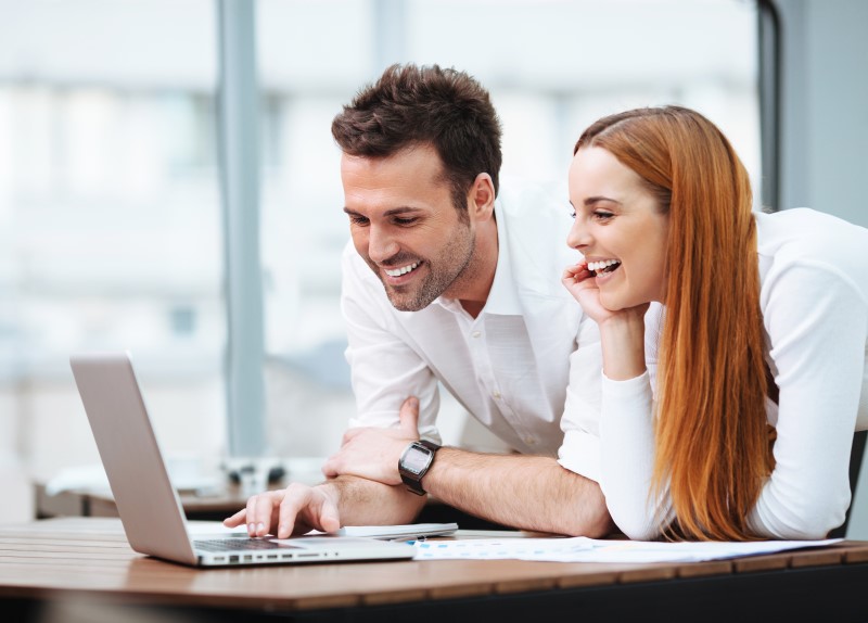 Men and woman preparing for an interview using a laptop