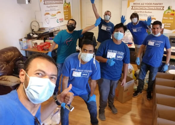 Group of community workers posing while wearing face masks