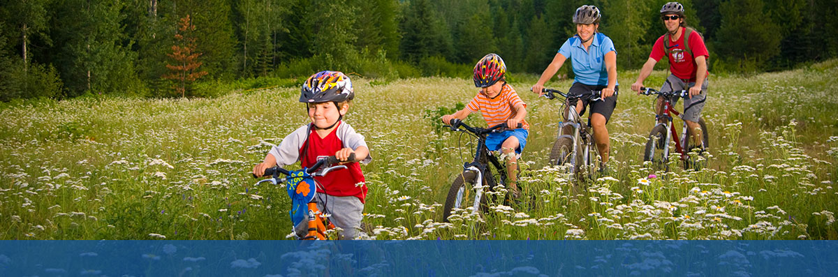 familiy biking in meadow