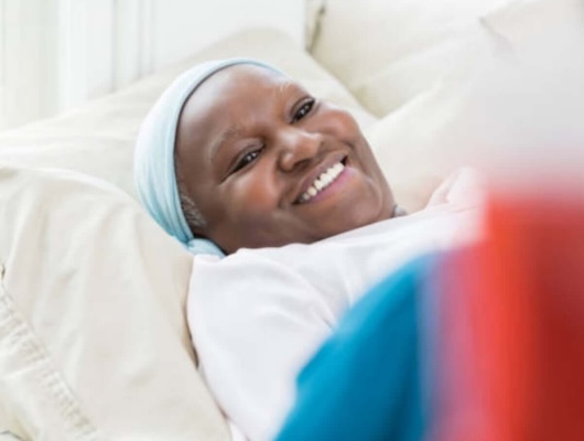Woman smiling from a bed