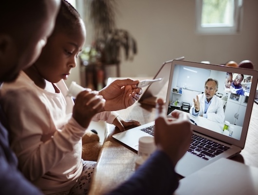 Father and daughter using telehealth