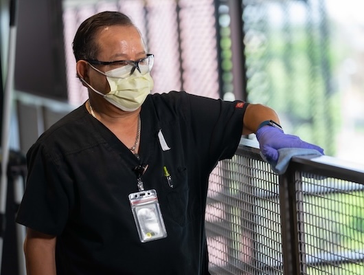 Man cleaning handrail