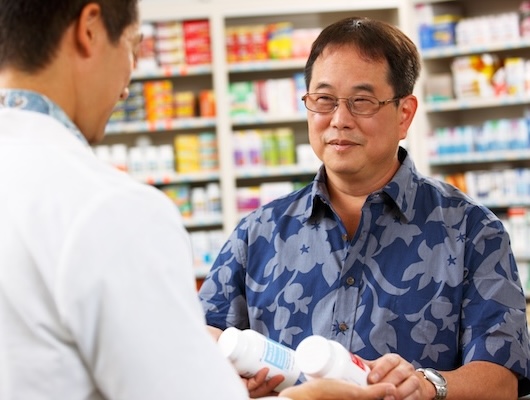 Man smiling at a pharmacist