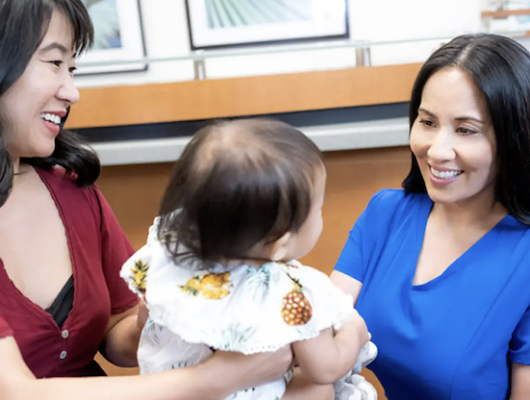Medical Assistant with baby patient and mom