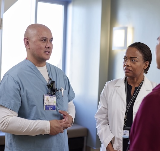 Nurse Tech speaking with colleagues