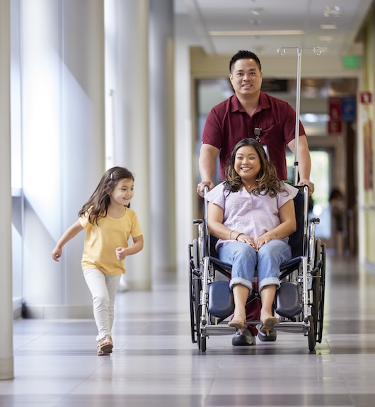 Medical Assistant walking down hall with children