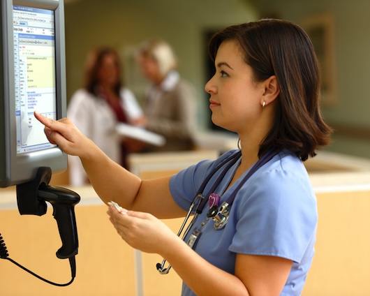 Clinical student tapping medical monitor screen