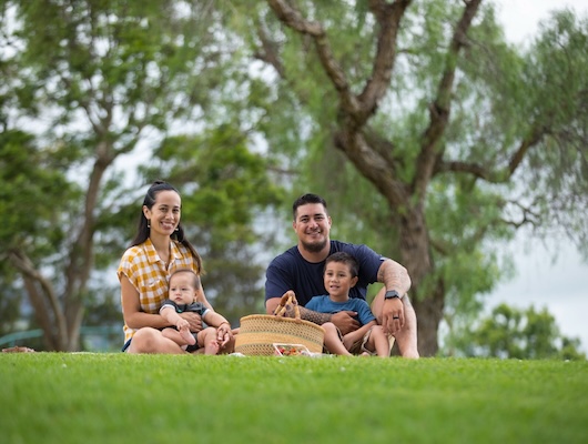 Parents picnicking with baby