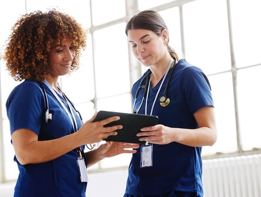 Ambulatory team members looking at tablet