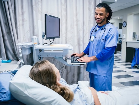 Critical Care nurse smiling at patient