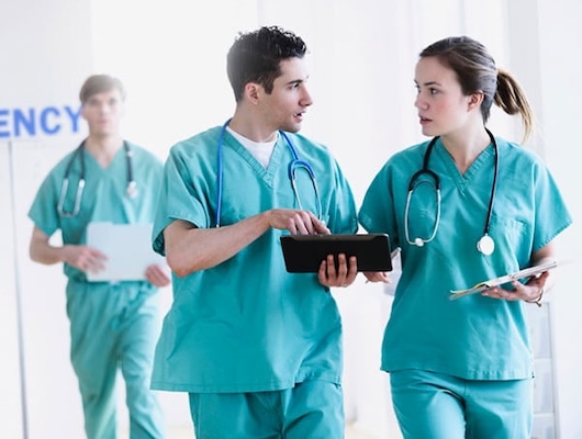 Emergency Department RNs talking and walking