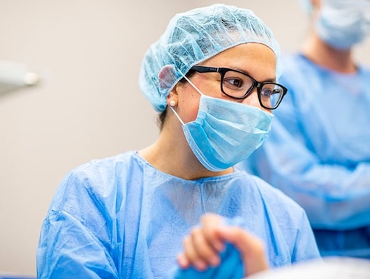 Medical Surgical RN looking at patient