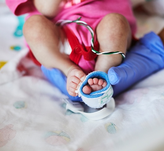 Baby foot in nurses hand
