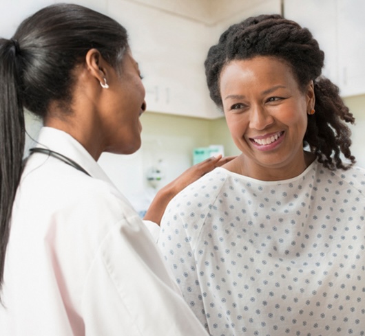 Clinician with hand on shoulder of patient