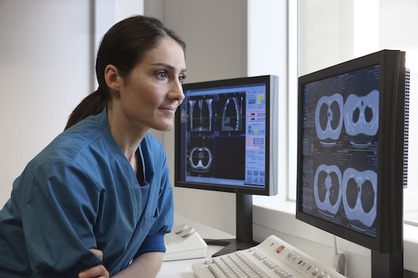 Imaging Tech reviewing xrays