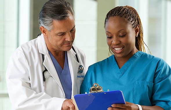 Medical Assistant looking at clipboard