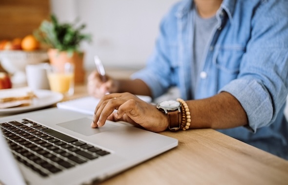 Person scrolling on a laptop