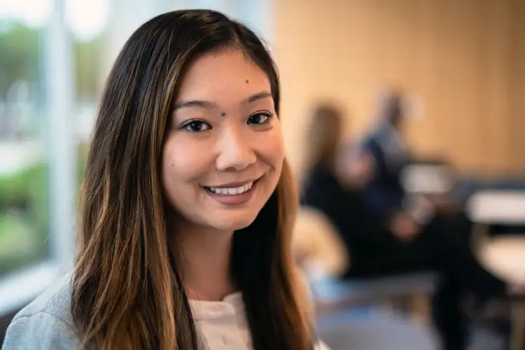 young professional woman smiling in an office