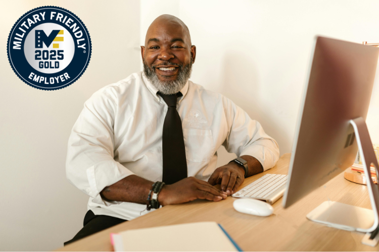 man working at computer smiling