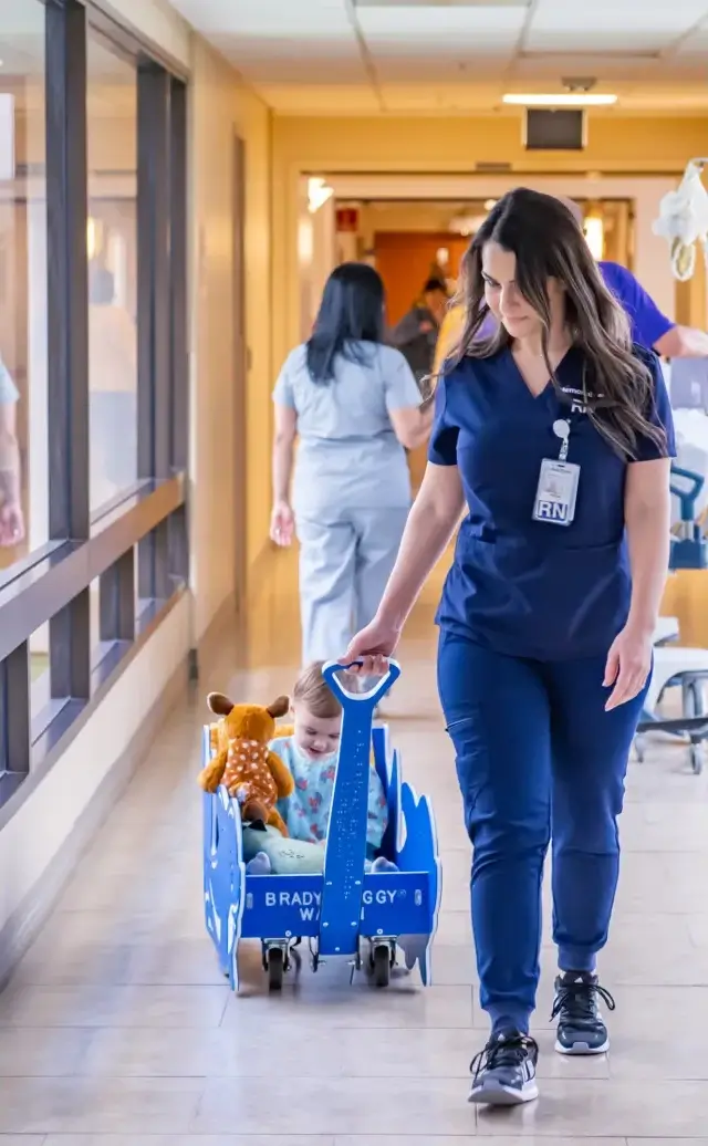 nurse pulling a child in a wagon