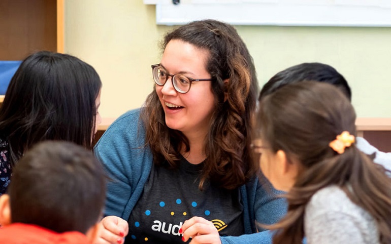 Woman speaking to several children