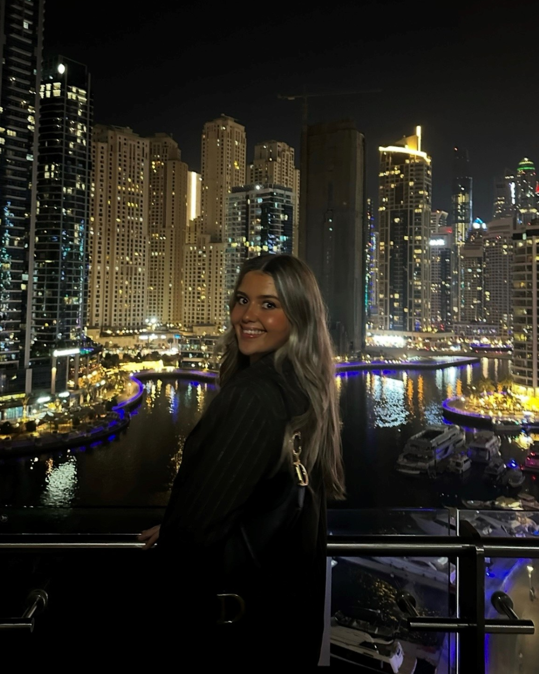 Colleague standing outdoors in a city at night