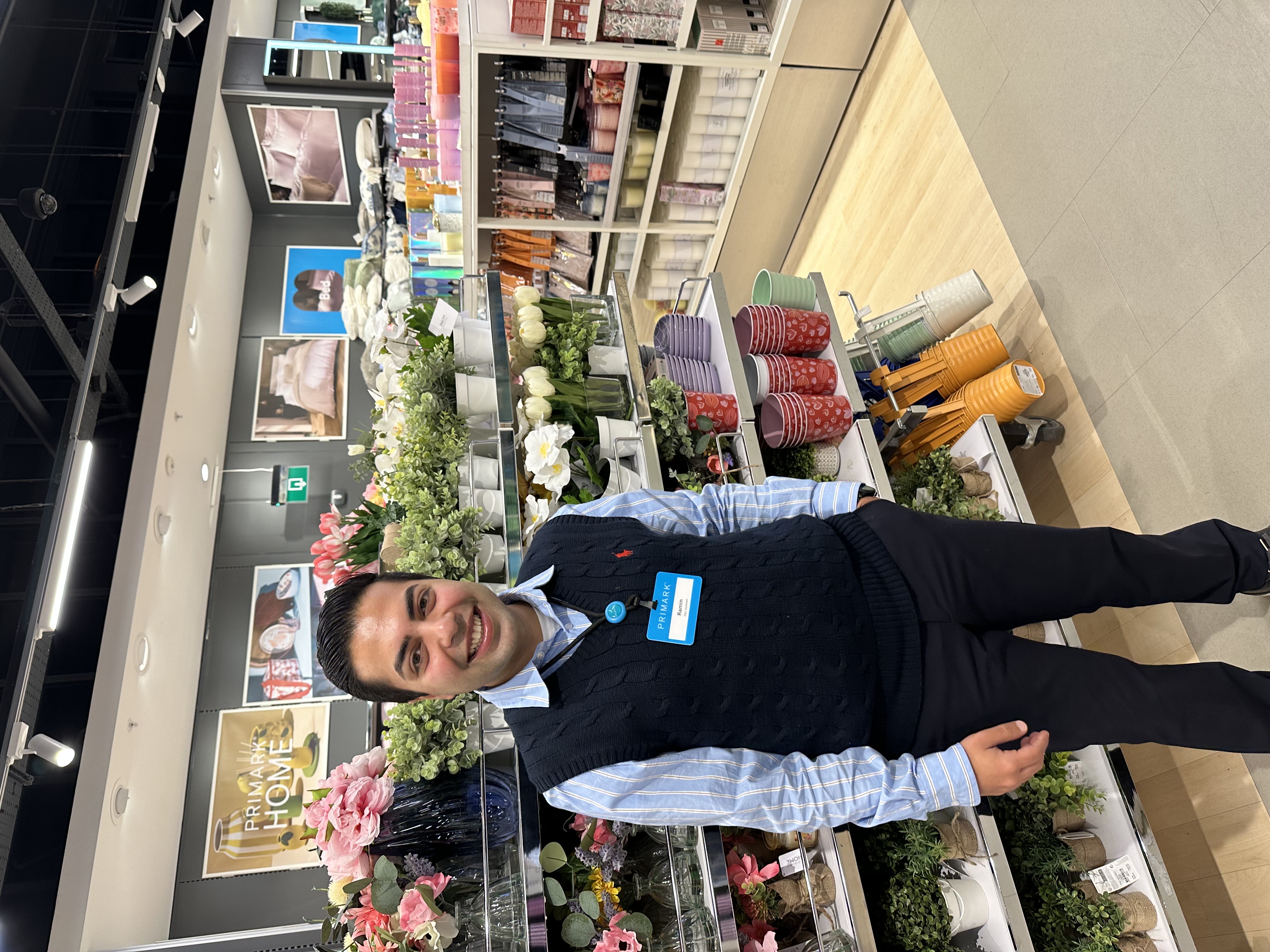 Colleague standing and smiling in store