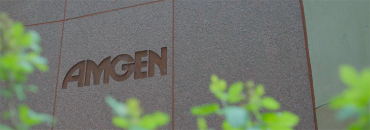 The Amgen logo is etched into the side of a building on campus.