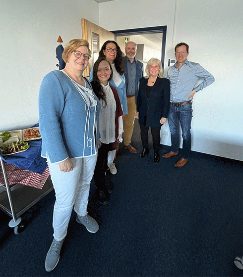 Diana with colleagues including Parexel's CEO, at the global submit of women, and boxing with a Parexel shirt.