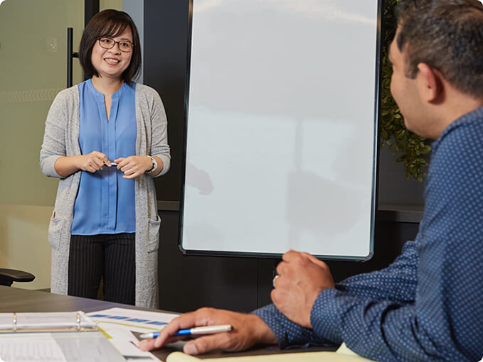 Two people having a strategy meeting in a conference room.