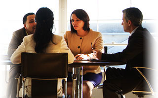 two small, separate groups of professionals discussing business matters
