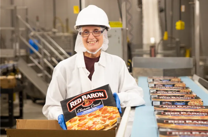 Woman holding a Red Baron Pizza box