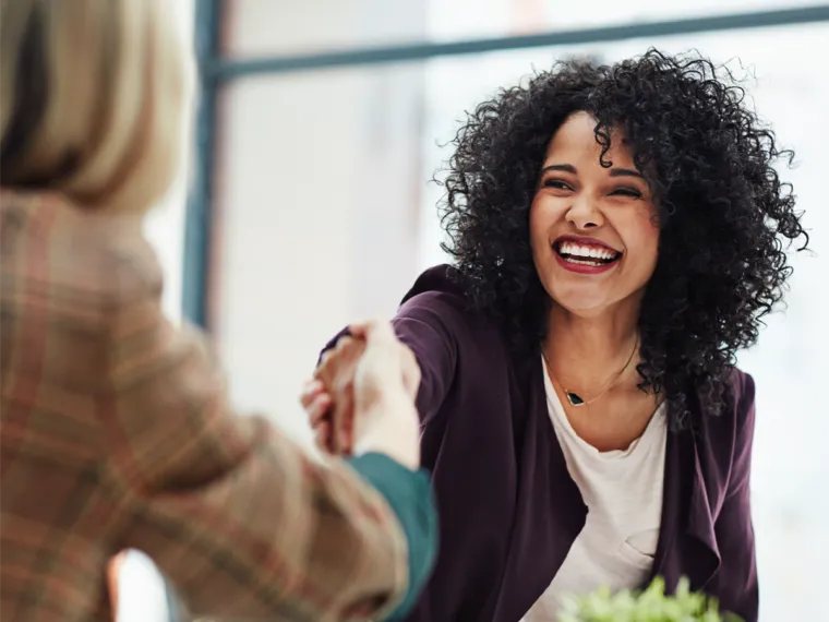 Woman shaking hands and smiling