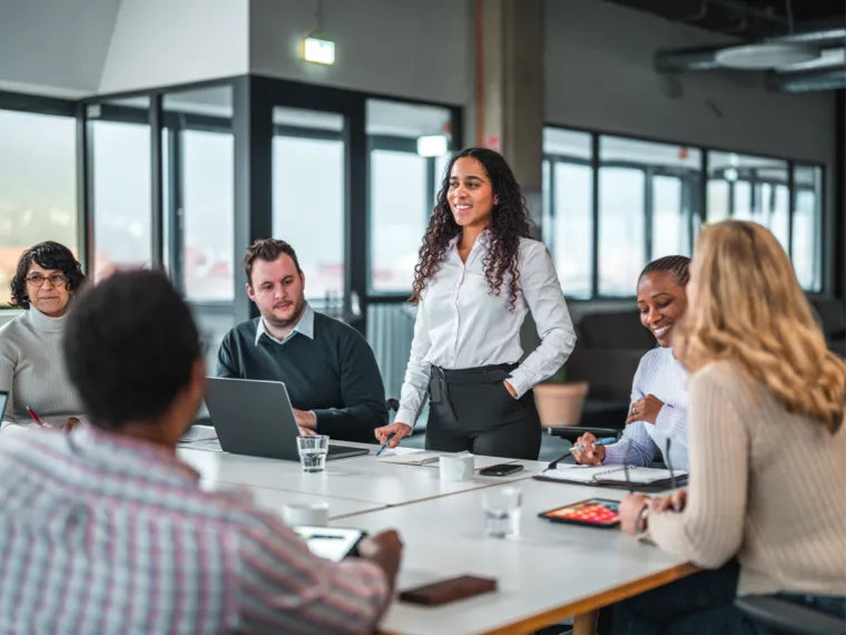 Woman standing in a conference room speaking