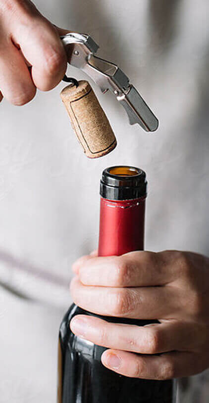 Chef opening a wine bottle