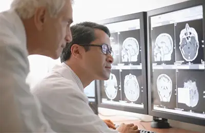 Two medical professionals looking at an x-ray