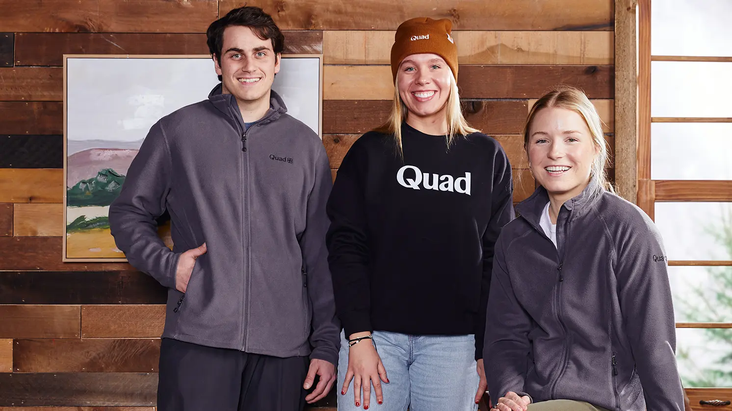 Corporate trainees wearing Quad branded clothing in a cabin