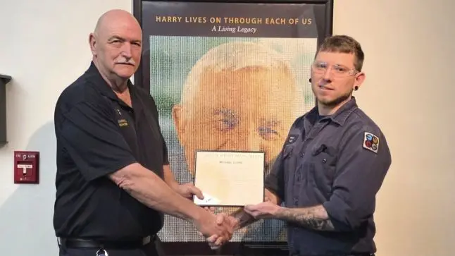 Portrait of Michael Lloyd receiving an award