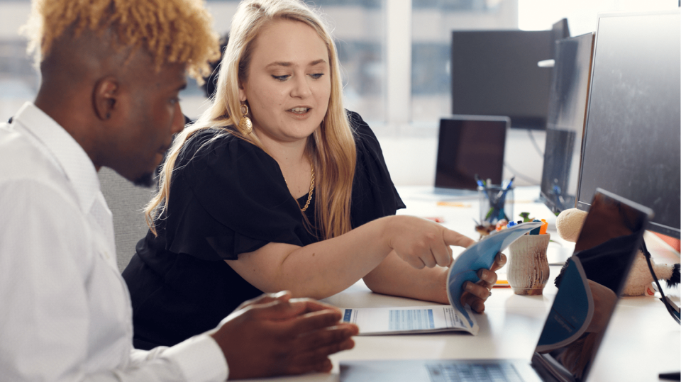 Quad accounting manager mentoring a junior employee