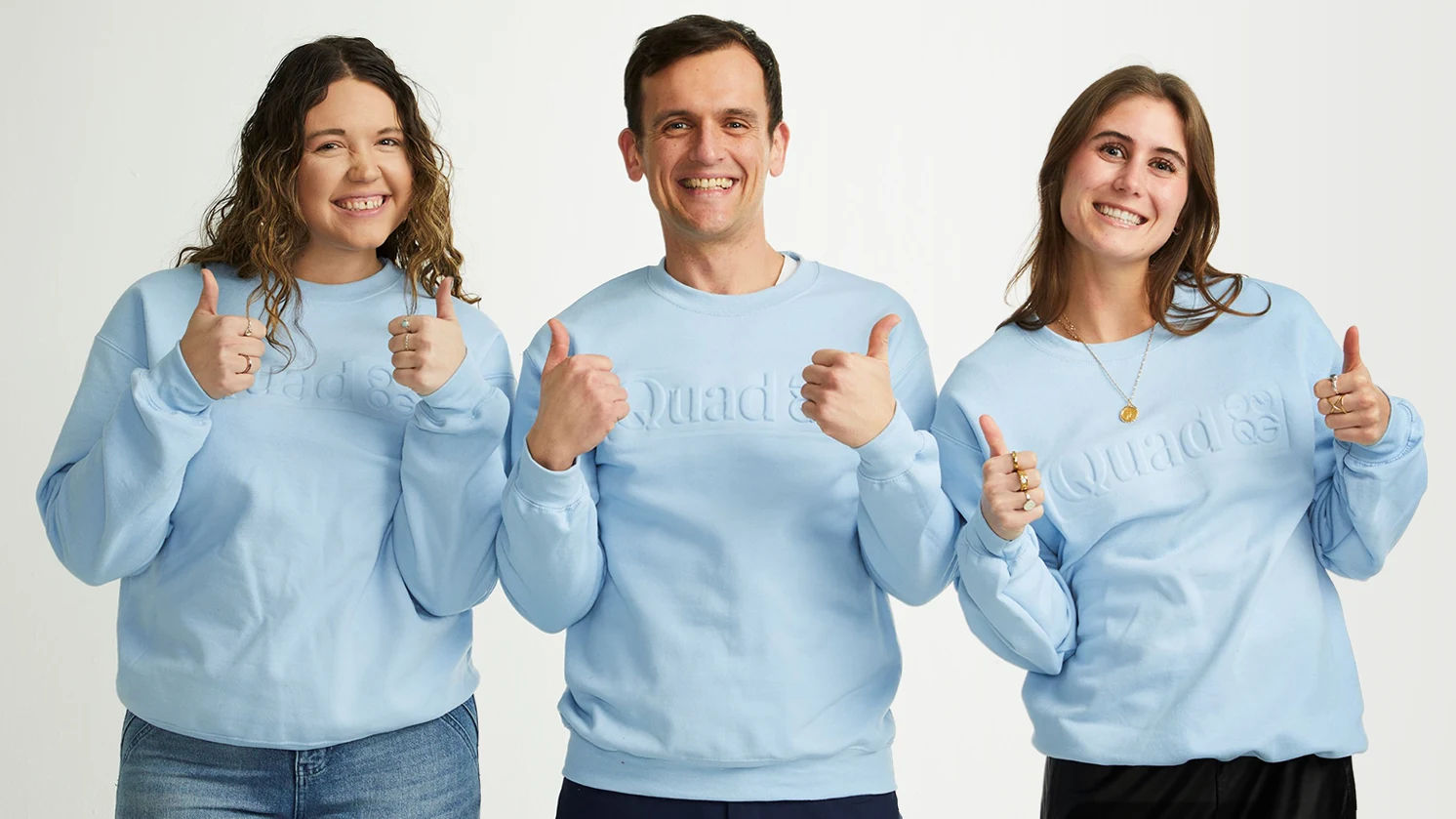 Employees in Quad sweatshirts