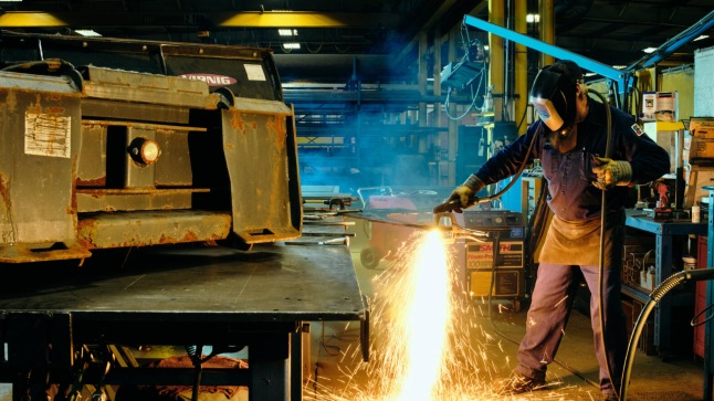 QuadMetalworks employee reworking parts using black oxide