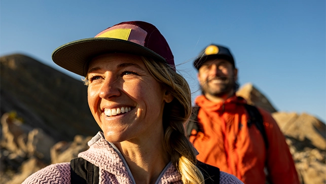 A Quad employee and their spouse hiking outside while on vacation