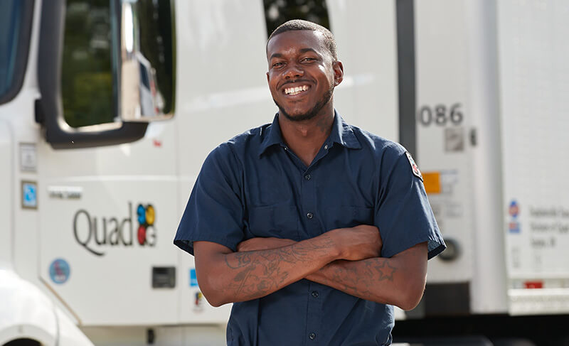 driver smiling in front of truck